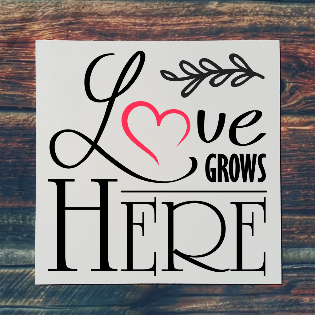 "Love grows here" with heart on 16x16 board